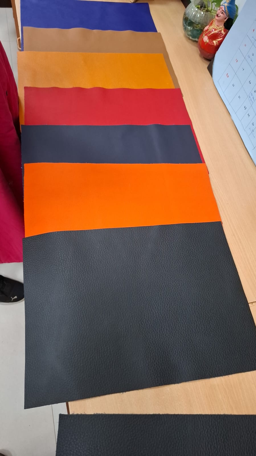 Laboratory leather samples finished with ERANDIQ and ANAKOTE in six distinct colors